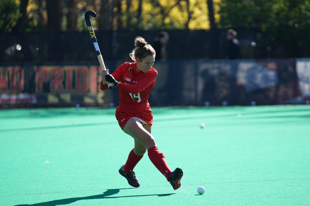 Female NCAA athlete playing lacrosse
